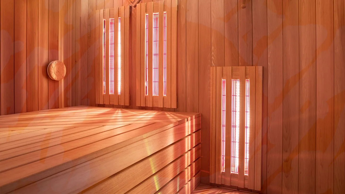 The cedar interior of the infrared sauna, lit warm